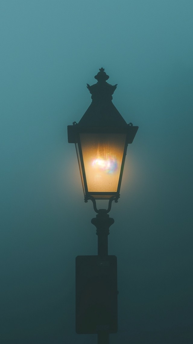 Street lamp in the fog wallpaper, soft glow, nighttime ambiance, background for mobile wallpaper (vertical)